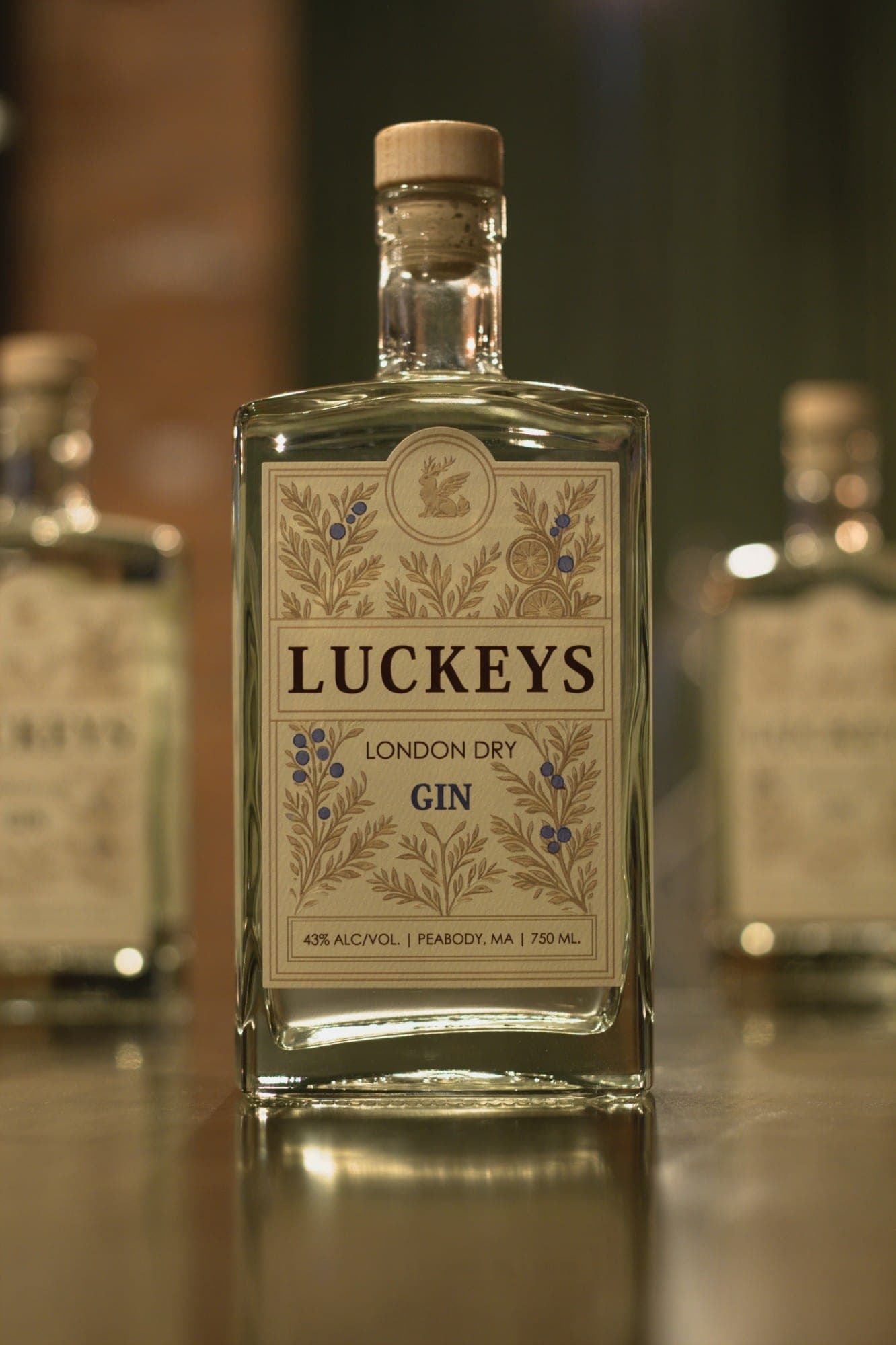 A bottle of Luckeys London Dry Gin on the bar top, in an arched cameo frame