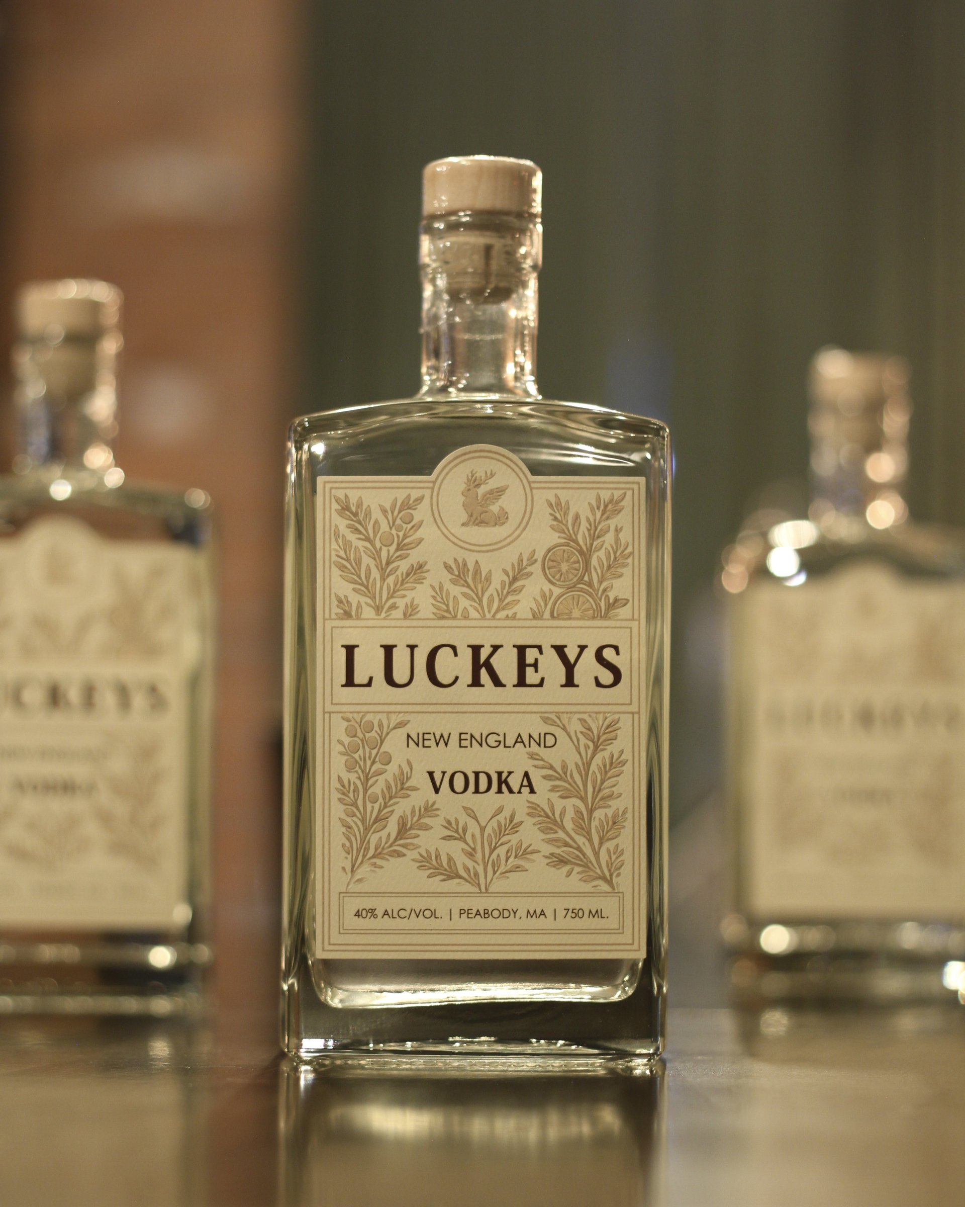 A bottle of Luckeys New England Vodka on the bar top, in an arched cameo frame